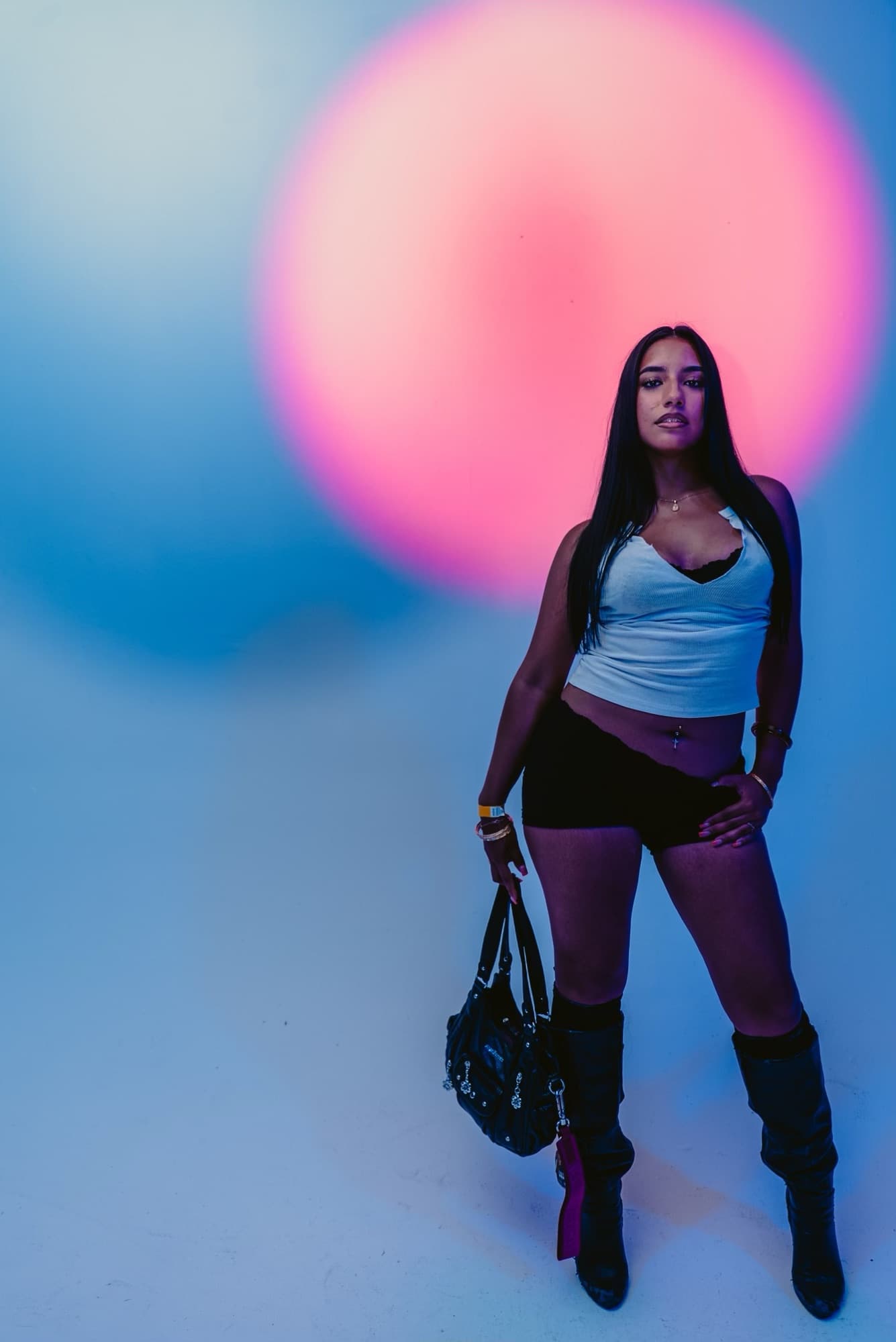 A guest posing against a pink backdrop