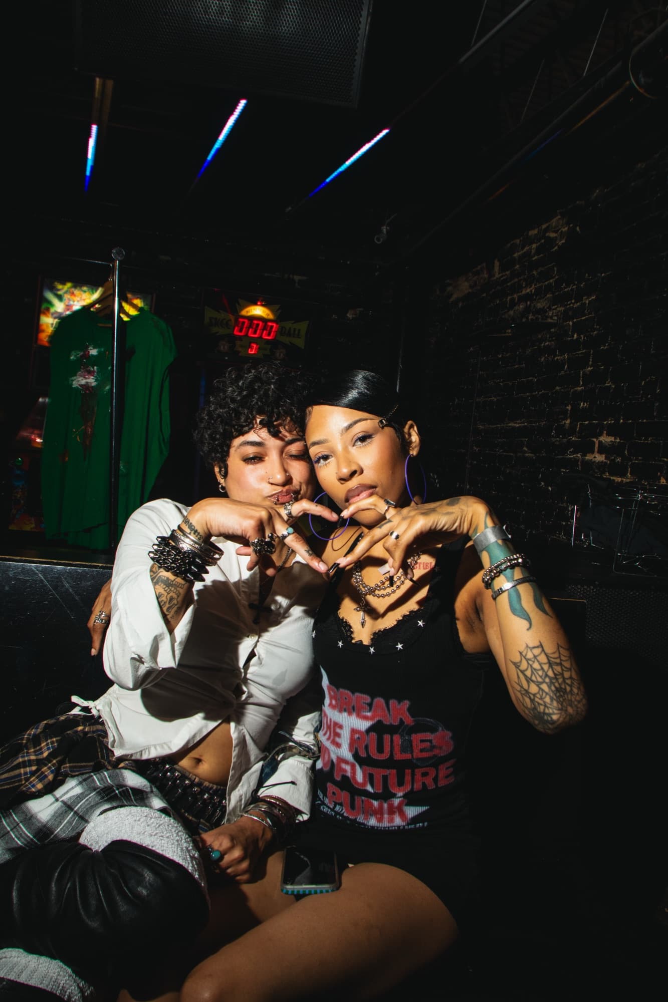 Two guests making hearts with their hands at Summer Nites
