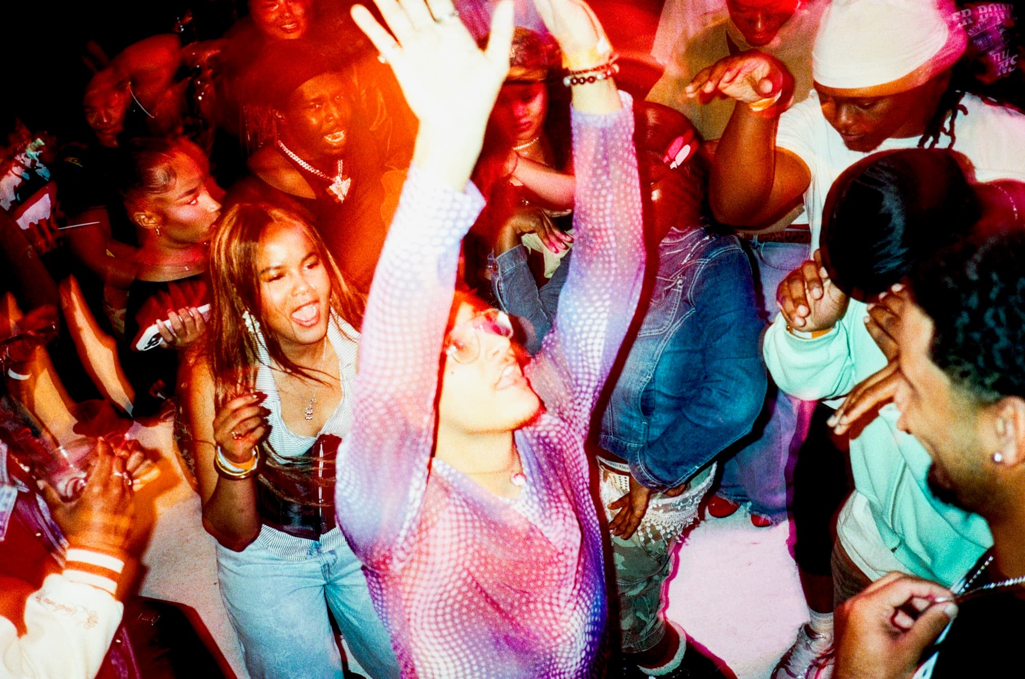 Dancers mid-move under red light at ONSET One