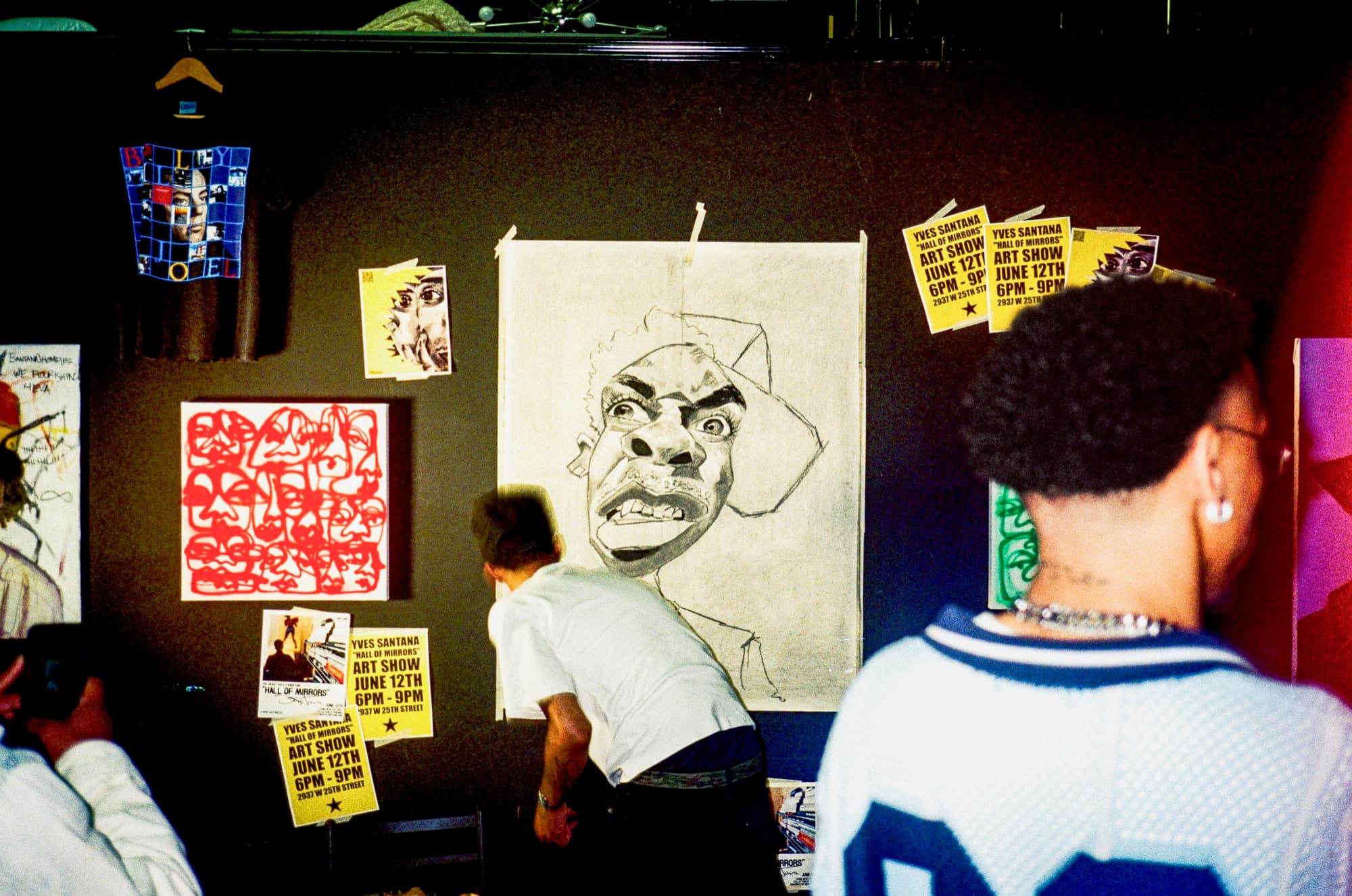Guests looking at hand-drawn portraits in the ONSET One exhibit